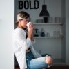 girl drinking the best coffee in the world detroit bold coffee strong coffee in background